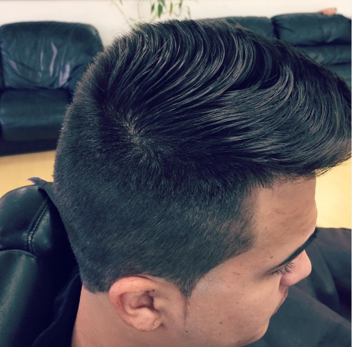 Textured pompadour with a clean taper fade